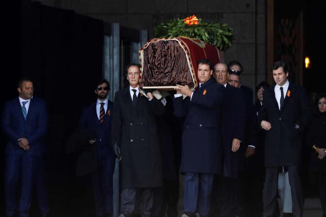 Family members carry the coffin of Spanish dictator Francisco Franco out of the Valley of the Fallen mausoleum