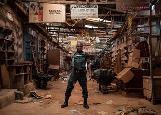 A security guard in the empty Ogbaru Market in 2017, closed to commemorate the 50th anniversary of the Nigerian Civil War