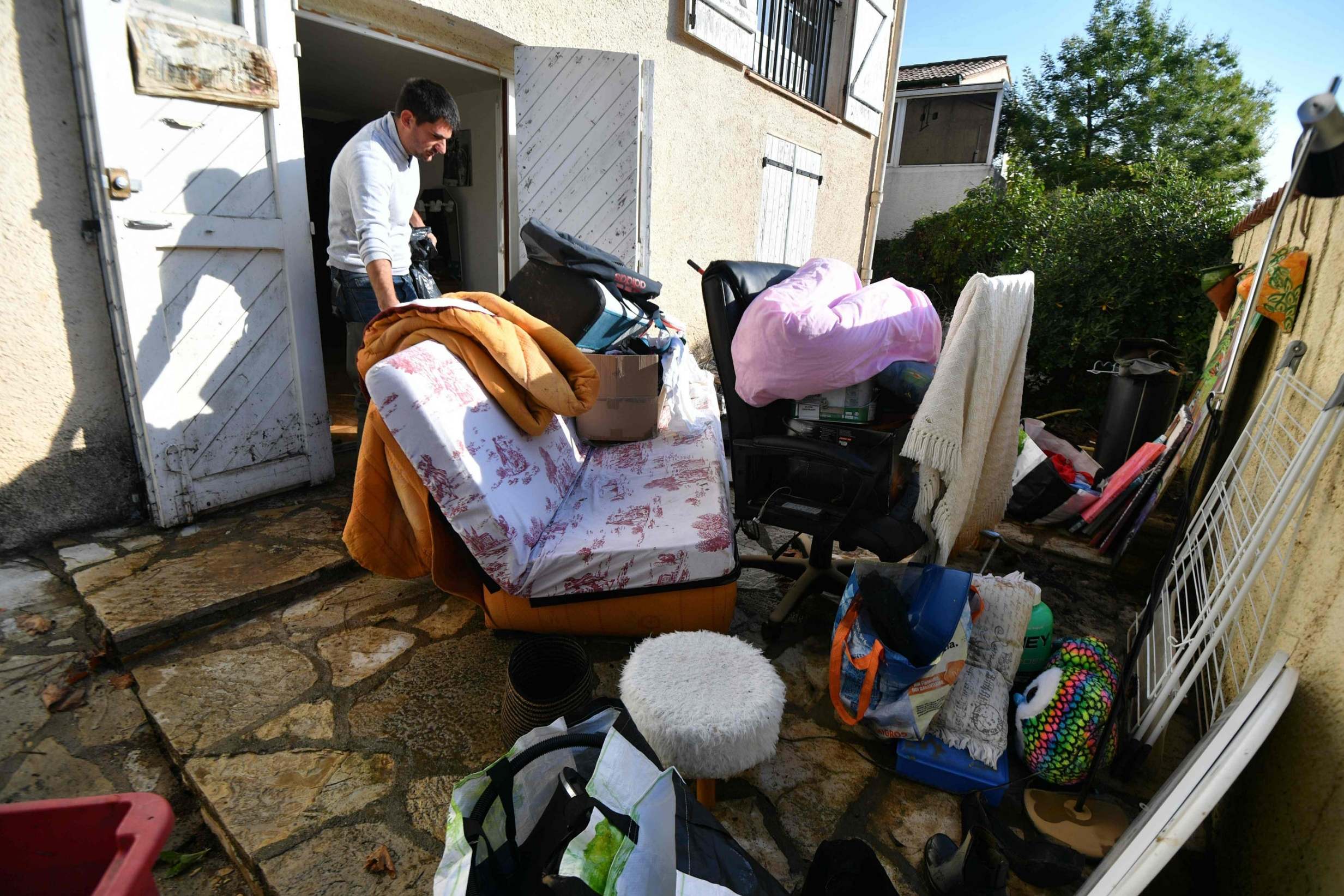 A resident cleans his house up the aftermath of powerful storms in Villeneuve-les-Beziers, southern France, on October 24, 2019. (Photo by PASCAL GUYOT/AFP via Getty Images)