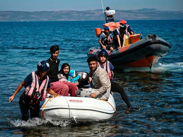 Migrants helped by rescuers arrive on the Greek island of Lesbos after crossing the Aegean Sea from Turkey