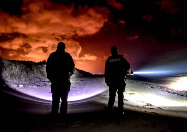 Gendarmes patrol on the beach of Oye-Plage, near Calais, as they try to intercept migrants attempting to cross the Channel