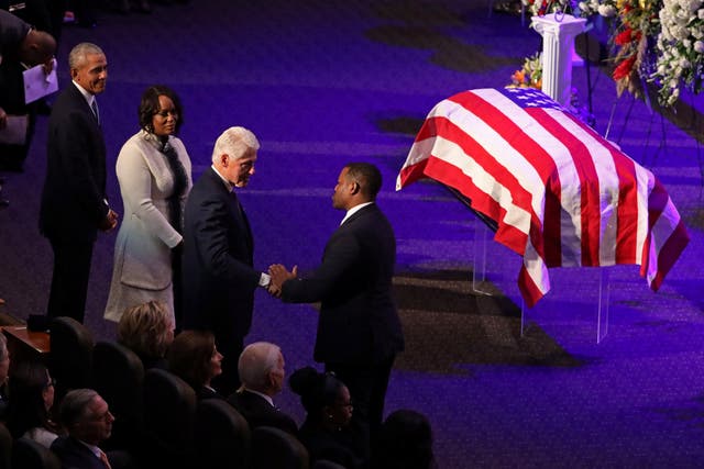 Bill Clinton shakes hands with Congressional staff member Harry Spikes as Barack Obama and Maya Rockeymoore look on at the funeral of her husband Elijah Cummings