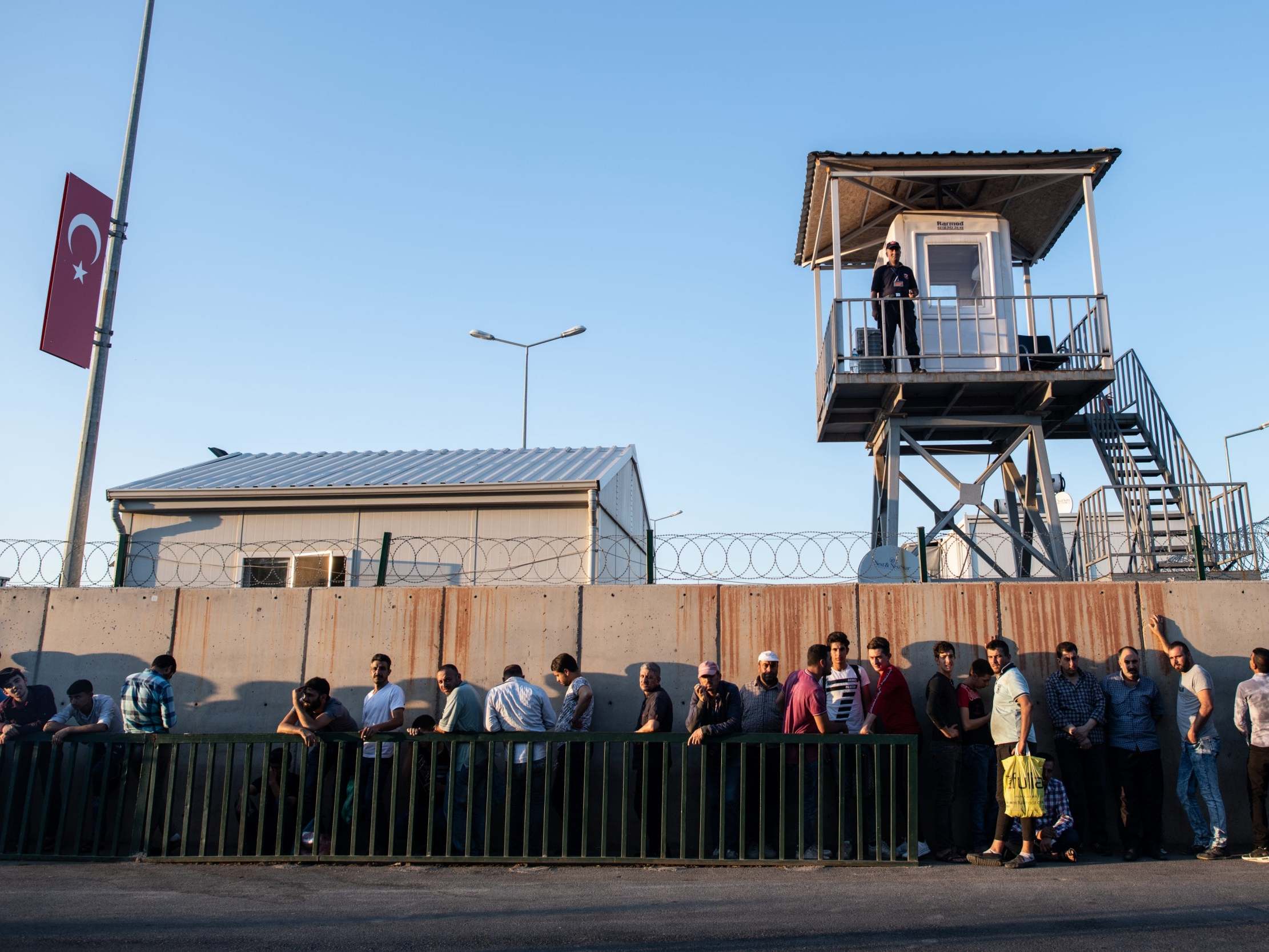 Syrian refugees wait in queue to enter to the Kahramanmaras refugee camp in southern Turkey (Getty)