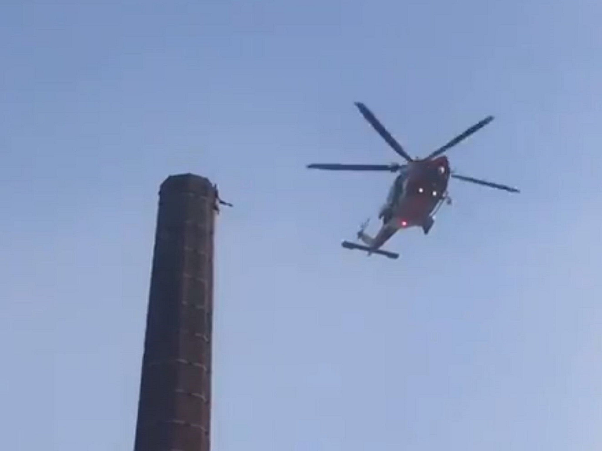 Still image from video footage of a man trapped at the top of the 290-ft Dixon's Chimney in Carlisle, 28 October, 2019.