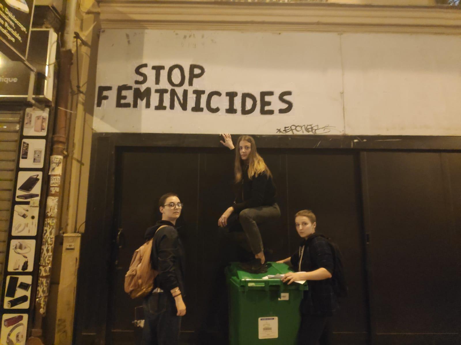 Juliette climbs onto a bin to make sure her sign is visible to Parisians passing by in the morning