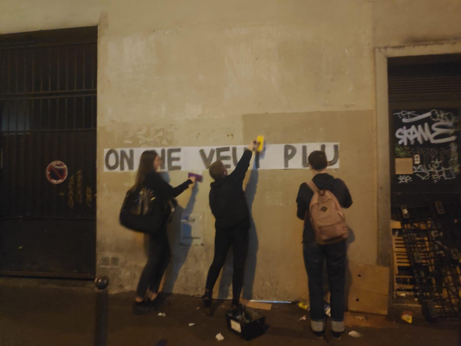 Members of the Collages Feminicide put up slogans denouncing femicide in Paris