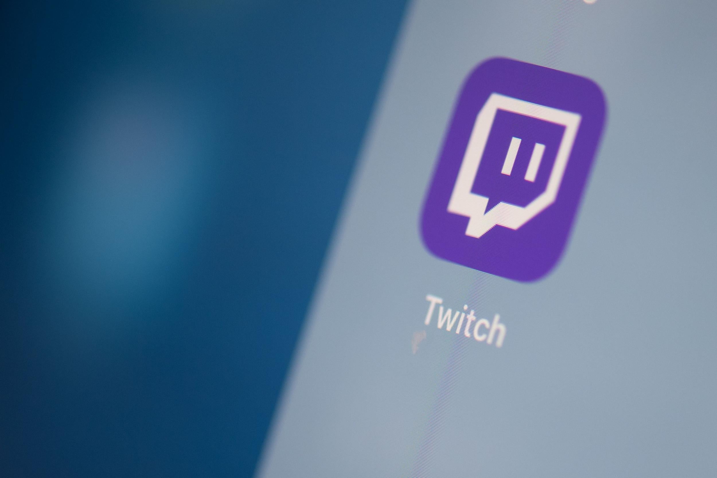 This illustration picture taken on July 24, 2019 in Paris shows the US live streaming video platform Twitch logo application on the screen of a tablet