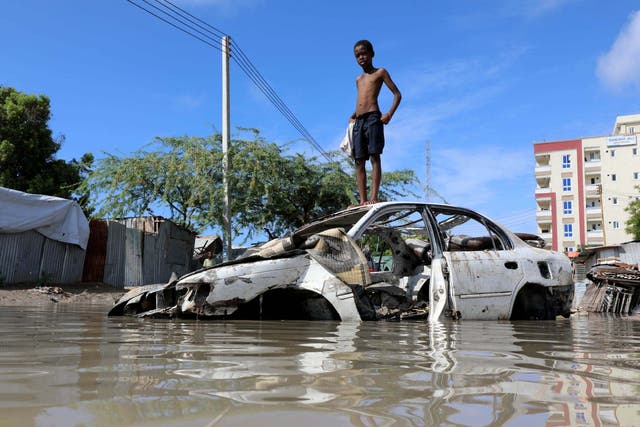 A Somali boy stands on a junk vehicle after heavy rain flooded their neighbourhood in Mogadishu, Somalia, 21 October, 2019.