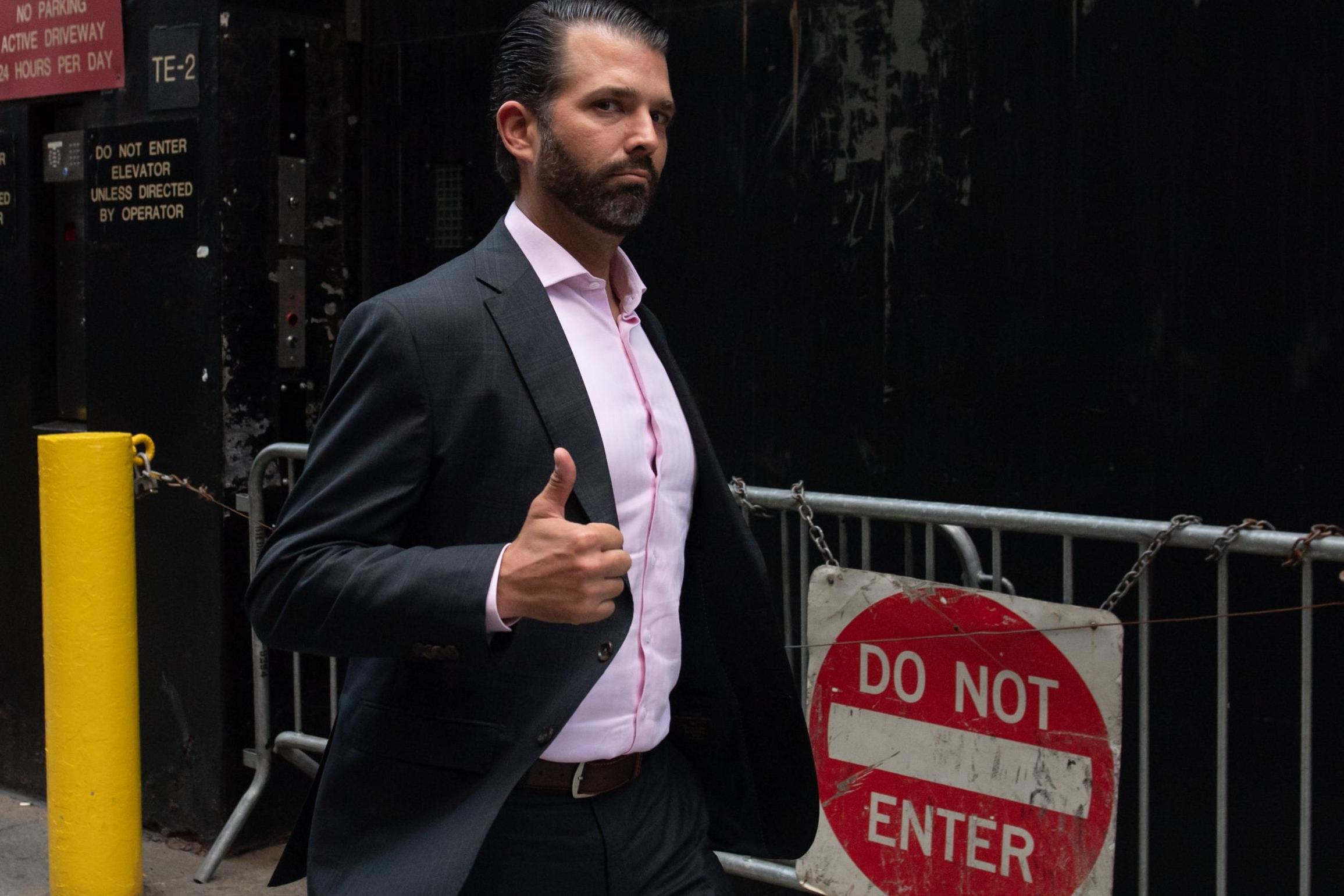 Donald Trump, Jr, son of President Donald Trump, gives a thumbs-up as he walks outside of Trump Tower in New York on 24 September, 2019.