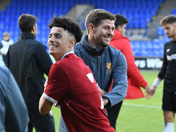 Curtis Jones celebrates with Steven Gerrard after defeating Sevilla in the Uefa Champions League