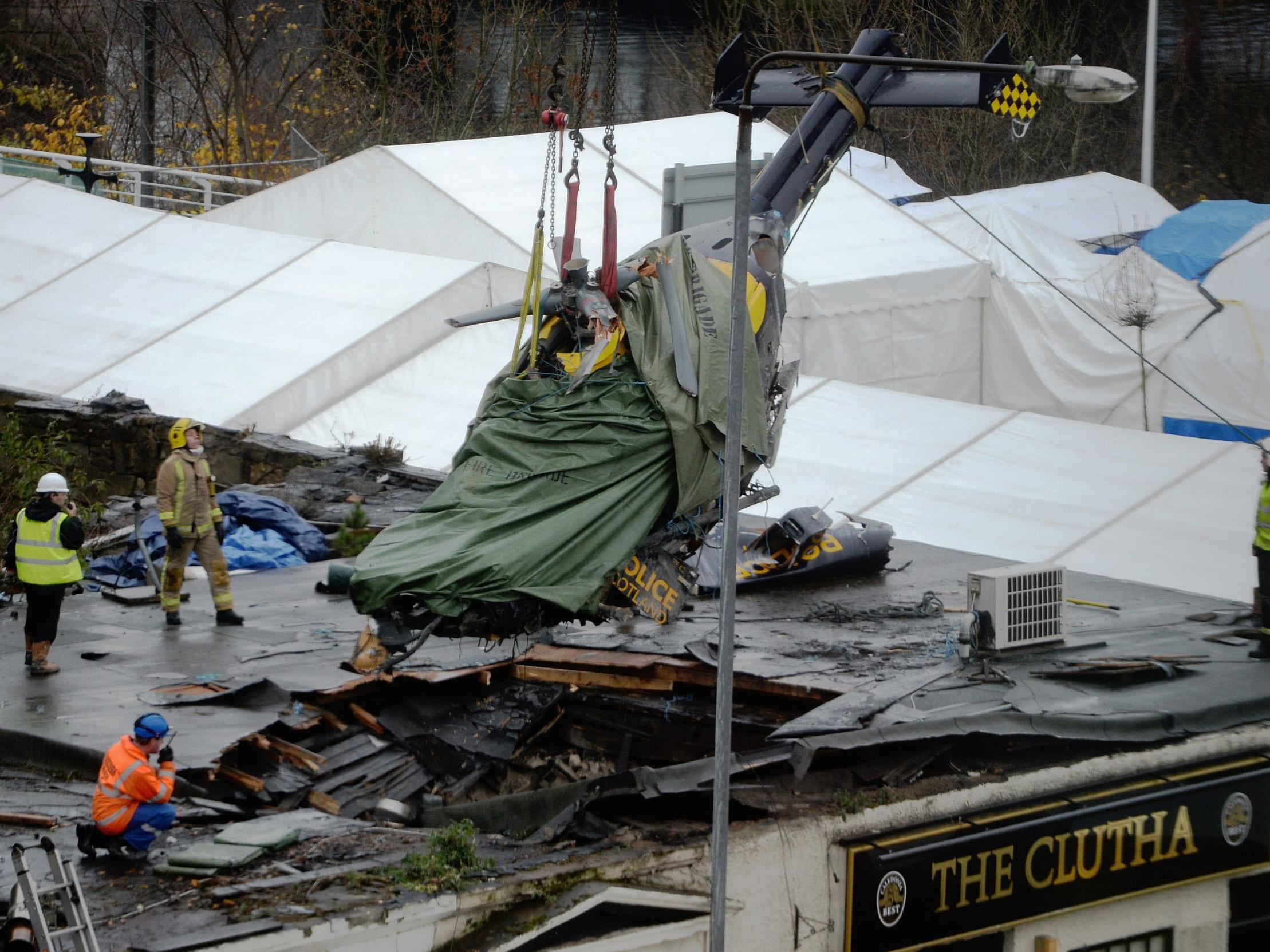 Rescuers lift the police helicopter wreckage from the roof of the Clutha pub in 2013
