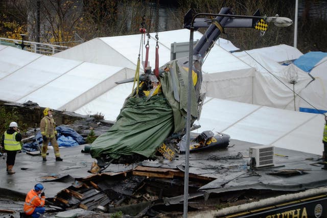 Rescuers lift the police helicopter wreckage from the roof of the Clutha pub in 2013