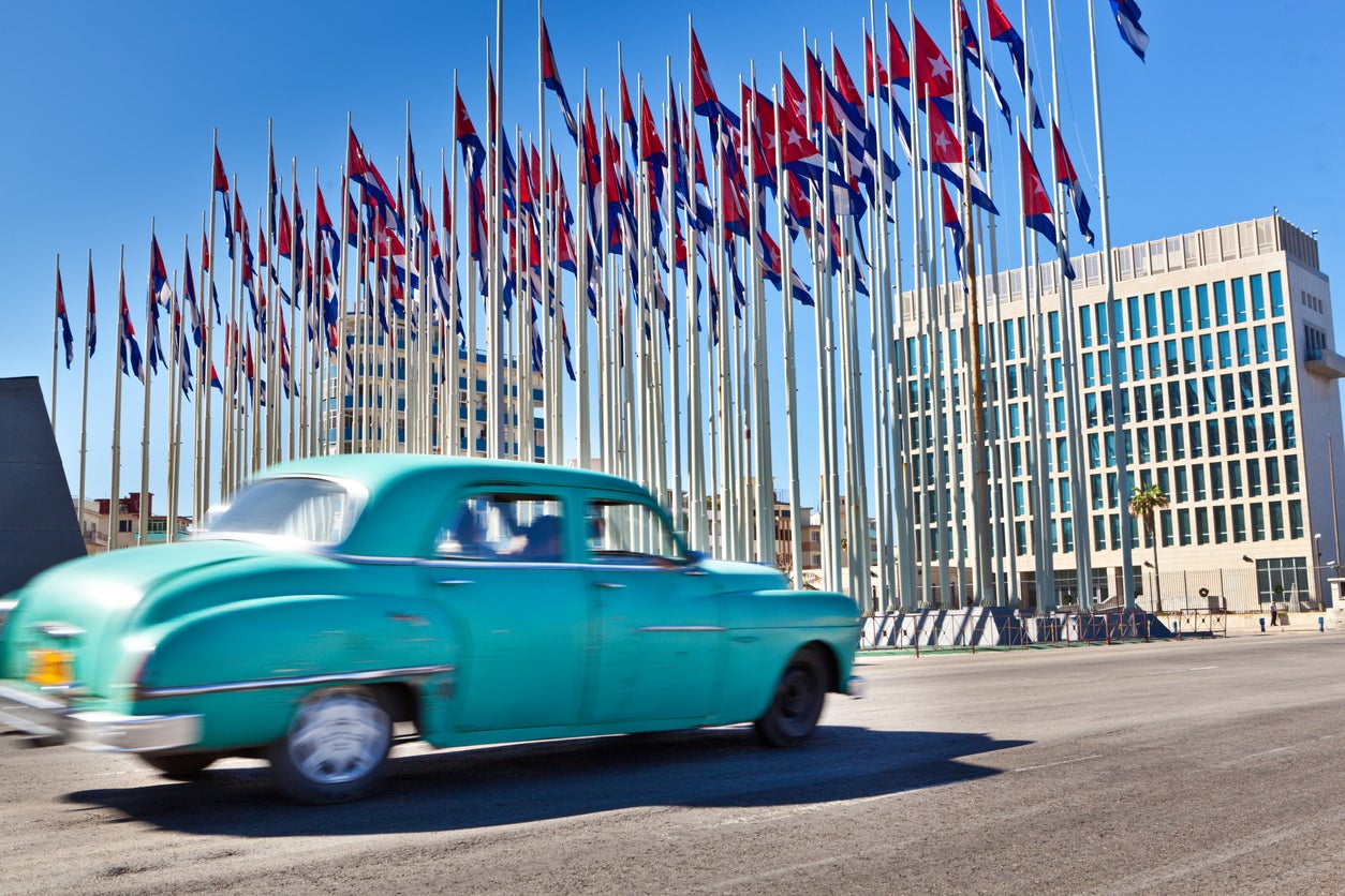 <p>The US embassy in Havana seen behind an array of Cuban flags where the first cases were reported in 2016 </p>