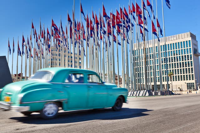 The US embassy in Havana seen behind an array of Cuban flags. In all, 26 US diplomatic staff suffered the effects of 'Havana syndrome'