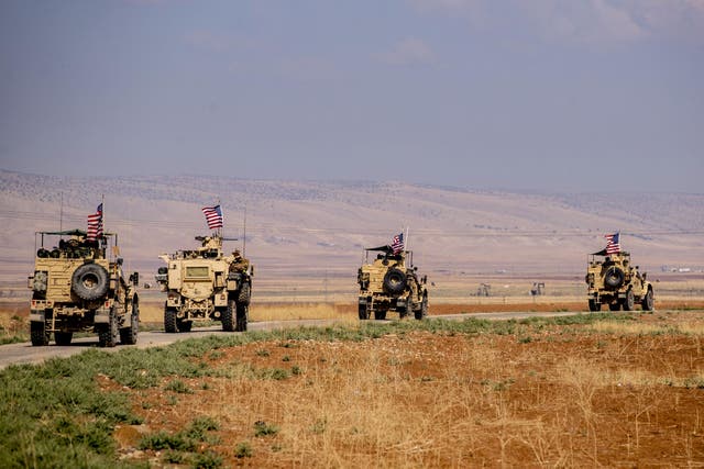 A convoy of US military vehicles drives through the Syrian northeastern town of Qahtaniyah on the border with Turkey on 31 October