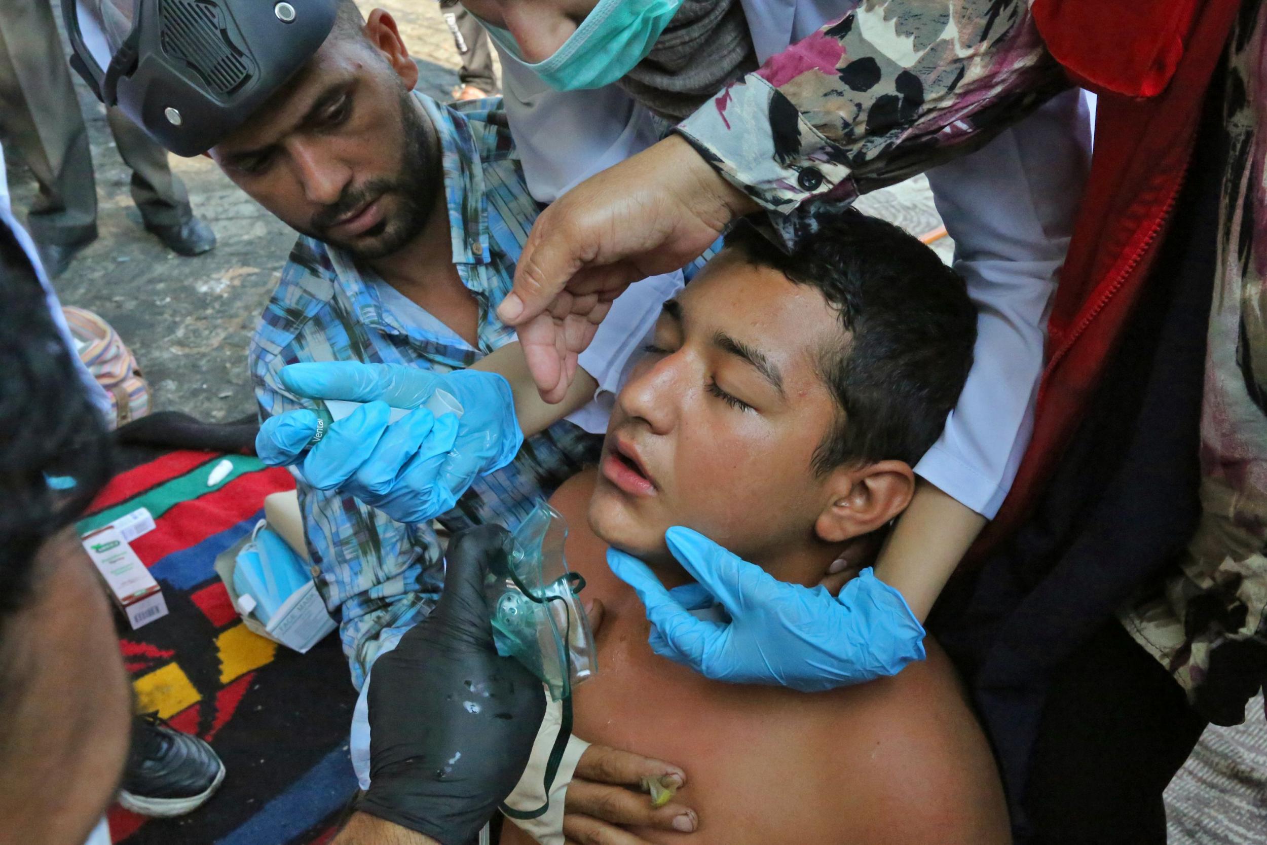 Iraqi protesters are treated for wounds during anti-government demonstrations in Tahrir square in the capital Baghdad on