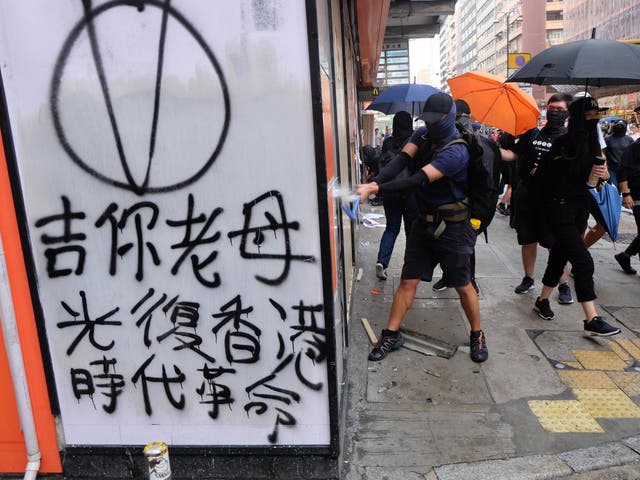 Protesters vandalise a shop seen to have links to China