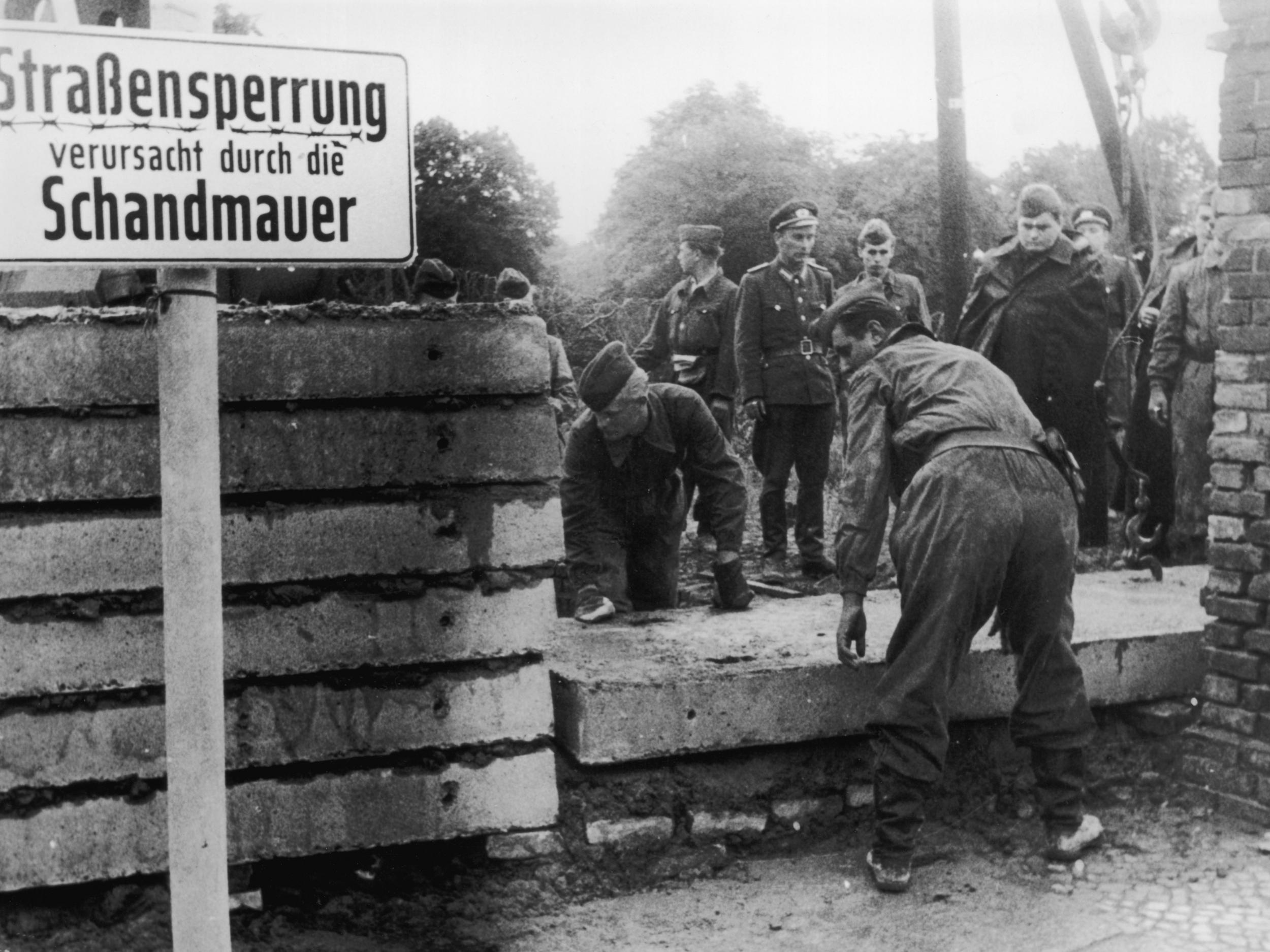 Soldiers building the Berlin Wall as instructed by the East German authorities in 1961