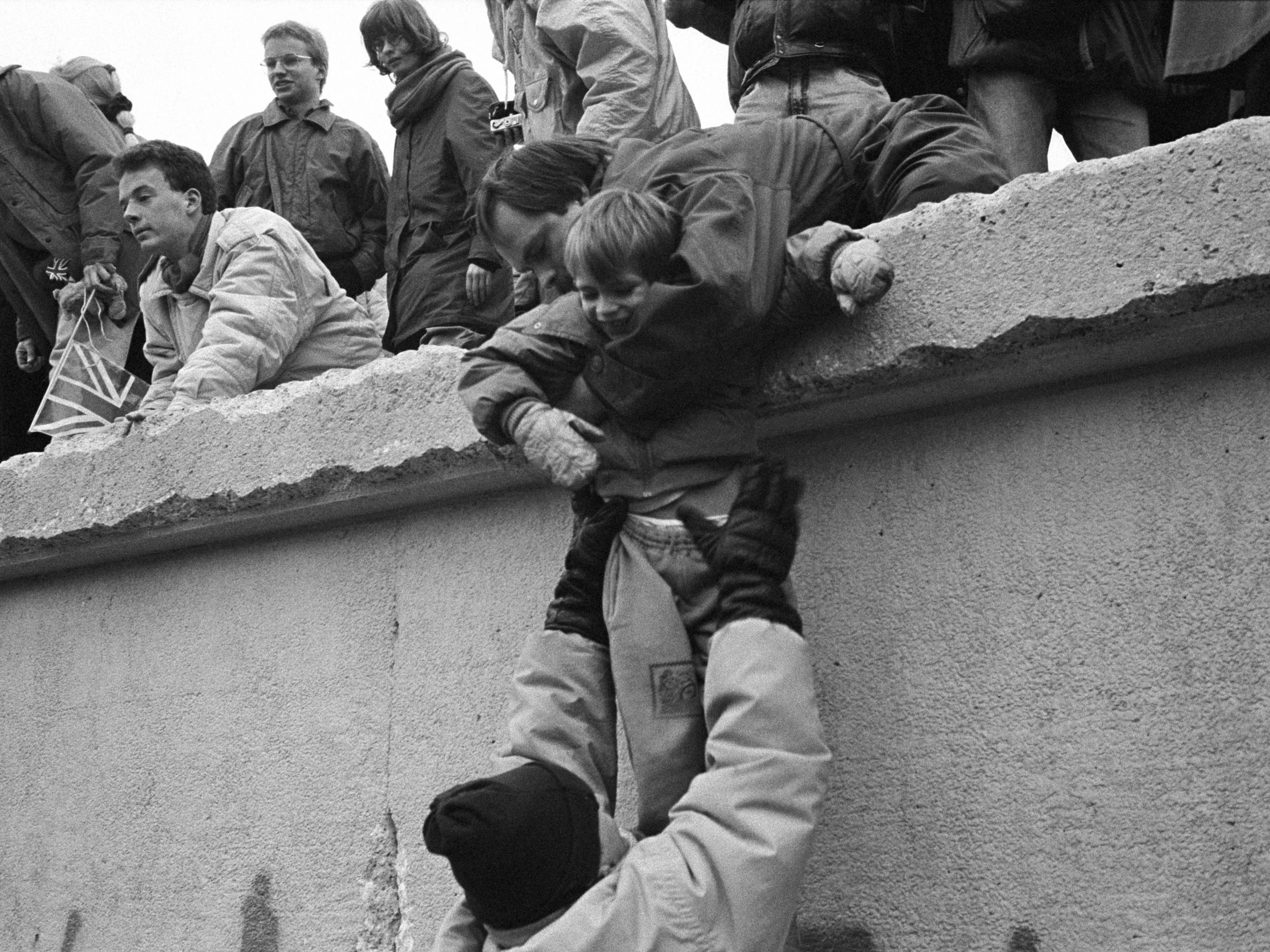 East Berliners climb onto the wall to celebrate the effective end of the city’s partition on?31?December 1989