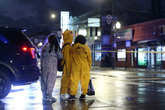 A group of children in Halloween costumes close to the spot in Chicago where a seven-year-old girl was shot and seriously injured while trick-or-treating
