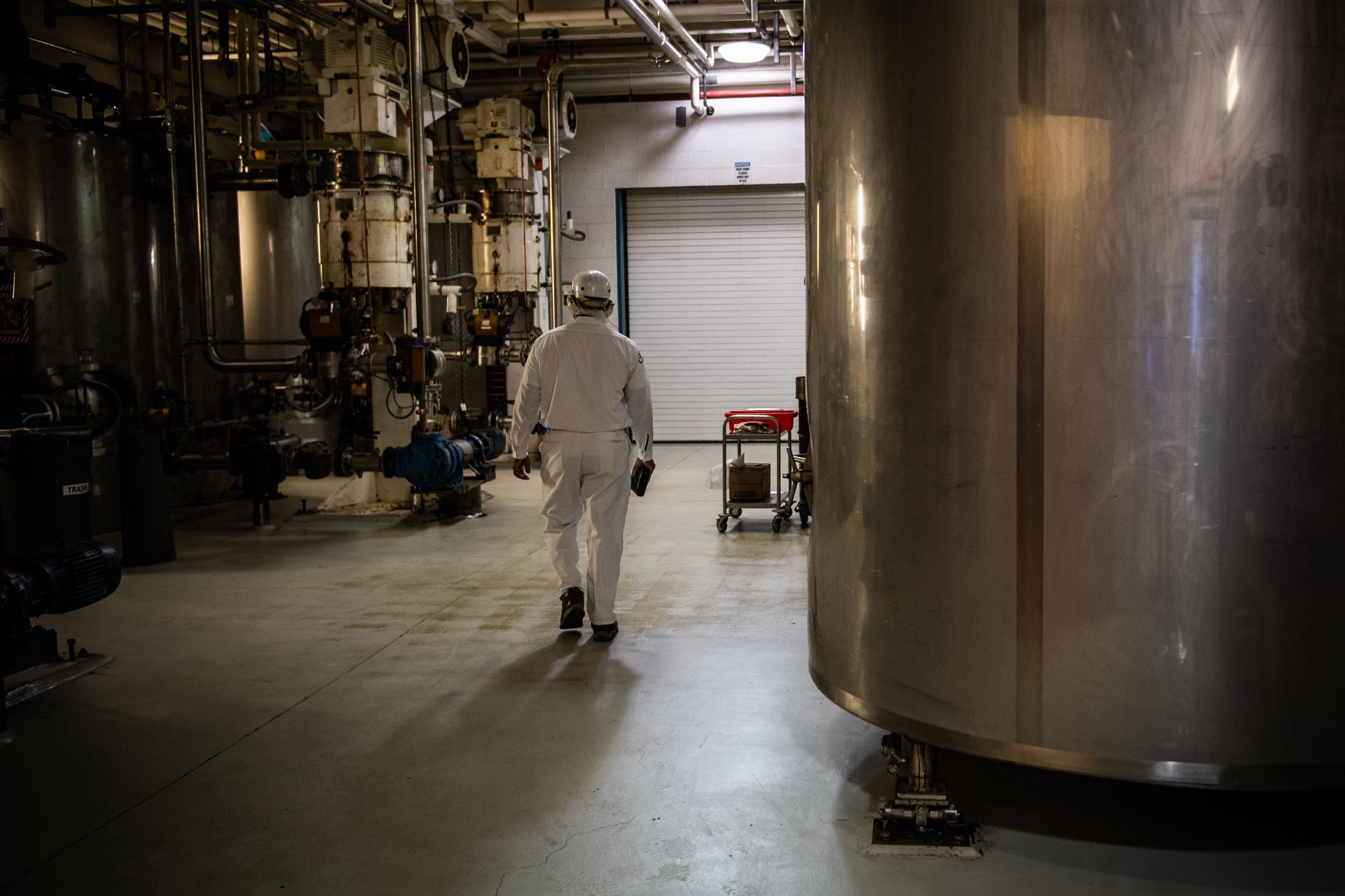 A Mars employee in Elizabethtown walks past equipment that is just one step in chocolate making