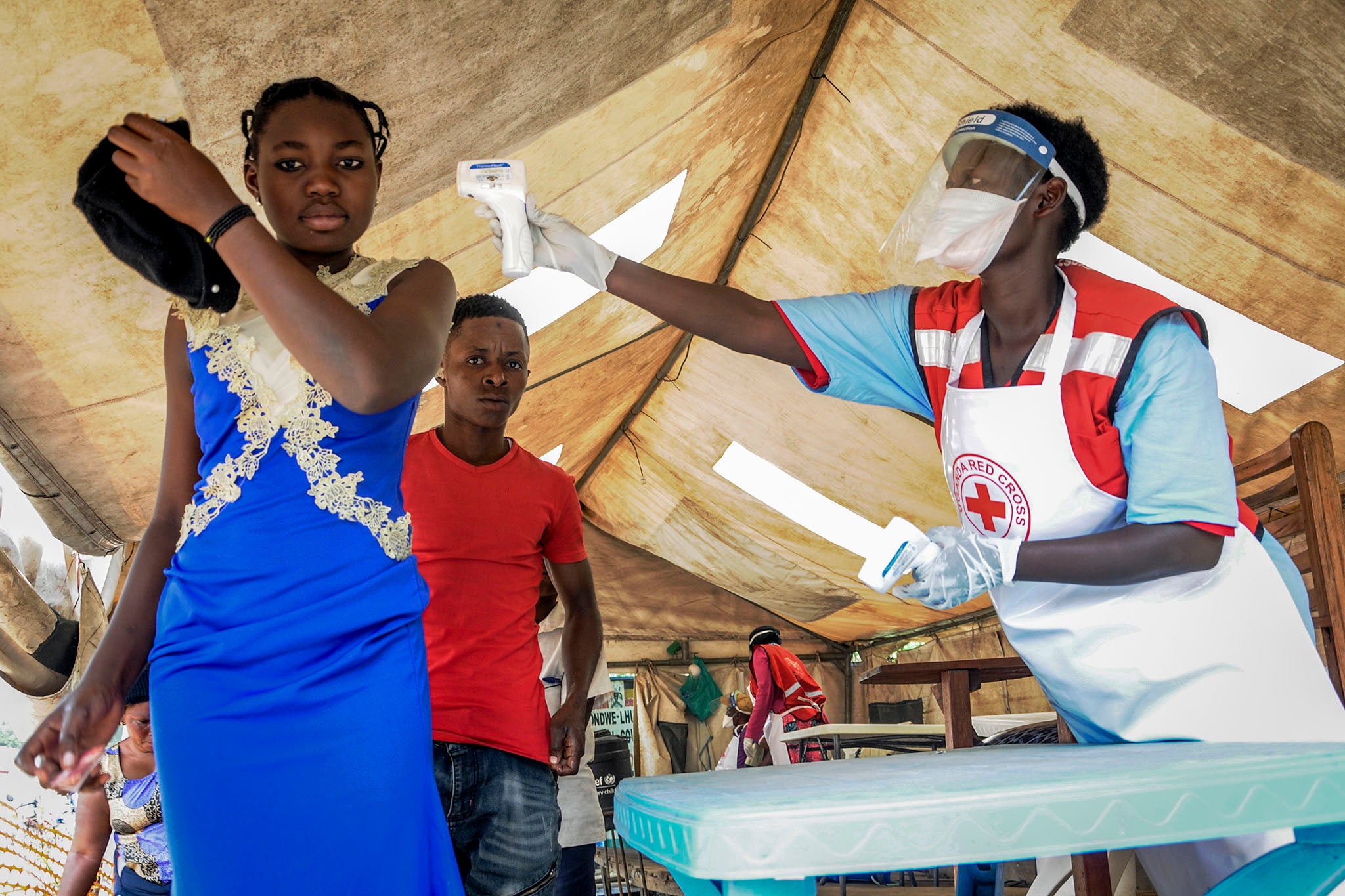 People coming from Congo are screened for symptoms of Ebola at the Ugandan border