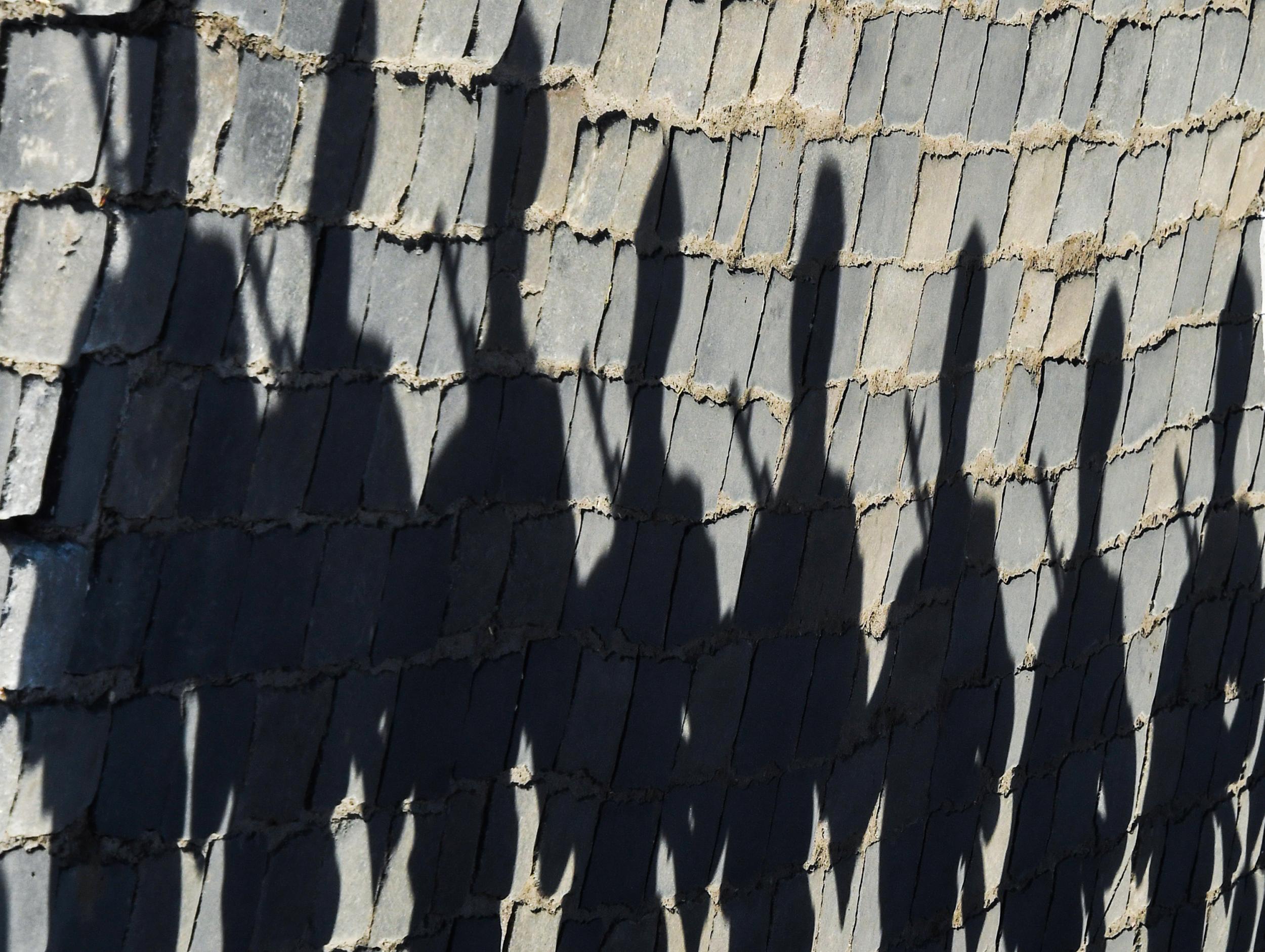 The shadows of Russian servicemen are seen on pavestones at Red Square prior to the Victory Day military parade in Moscow in 2018