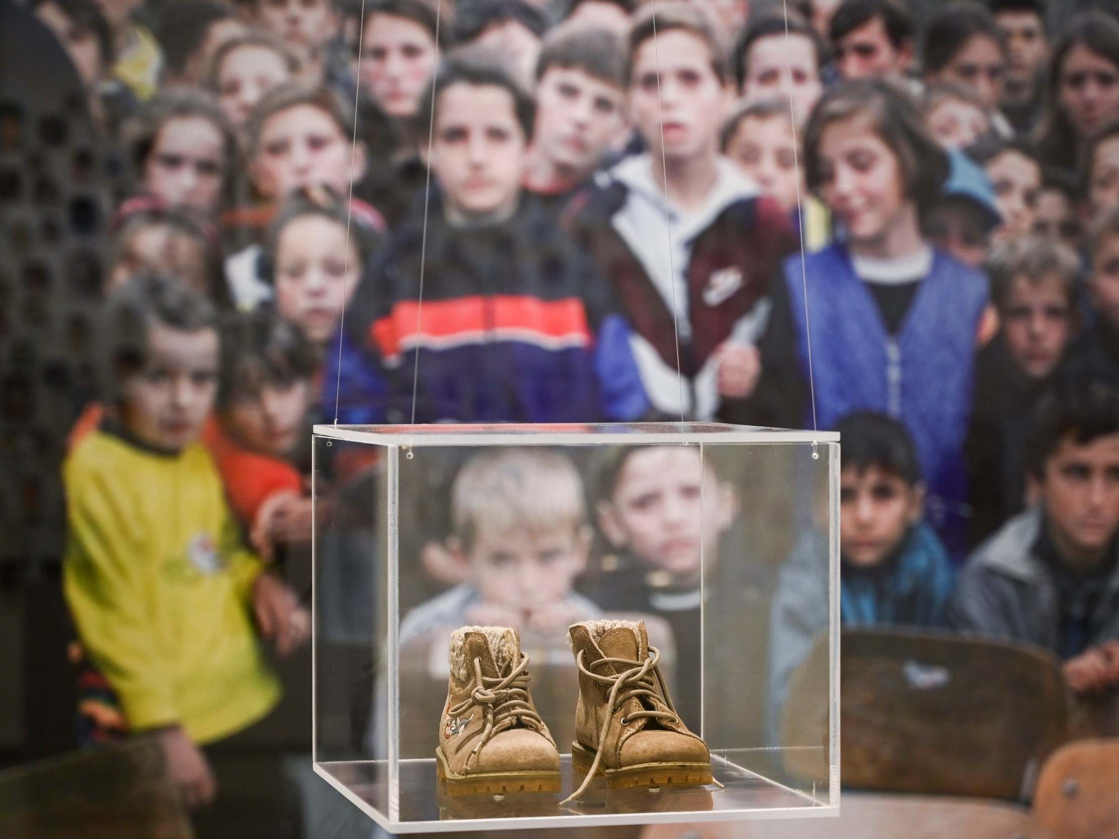 The shoes of Redon Berisha, killed when he was two-years-old during the Kosovo War, on display at the exhibition