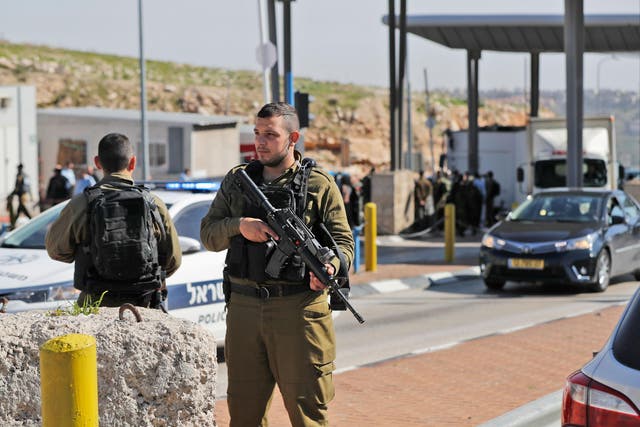 Israeli soldiers stand guard at the al-Zaim checkpoint on the outskirts of east Jerusalem