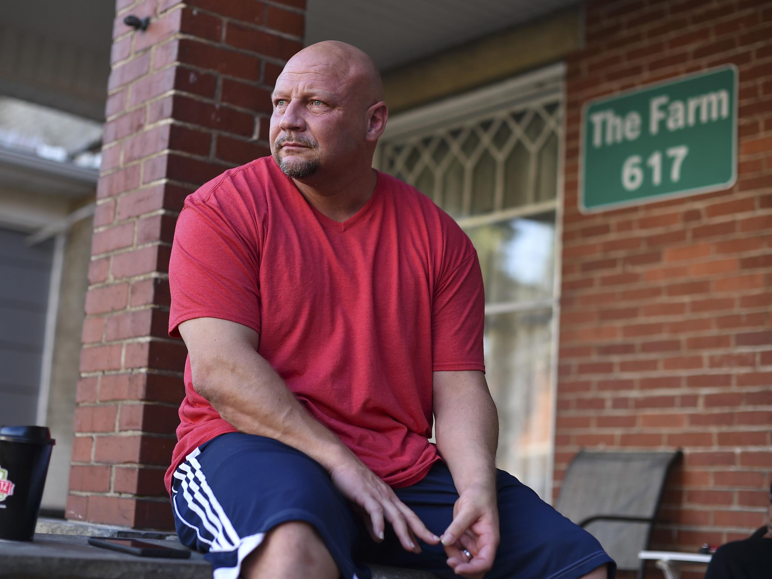 Rocky Meadows, founder of Lifehouse recovery and treatment centre and former addict, sits on the front porch of the Farm recovery house