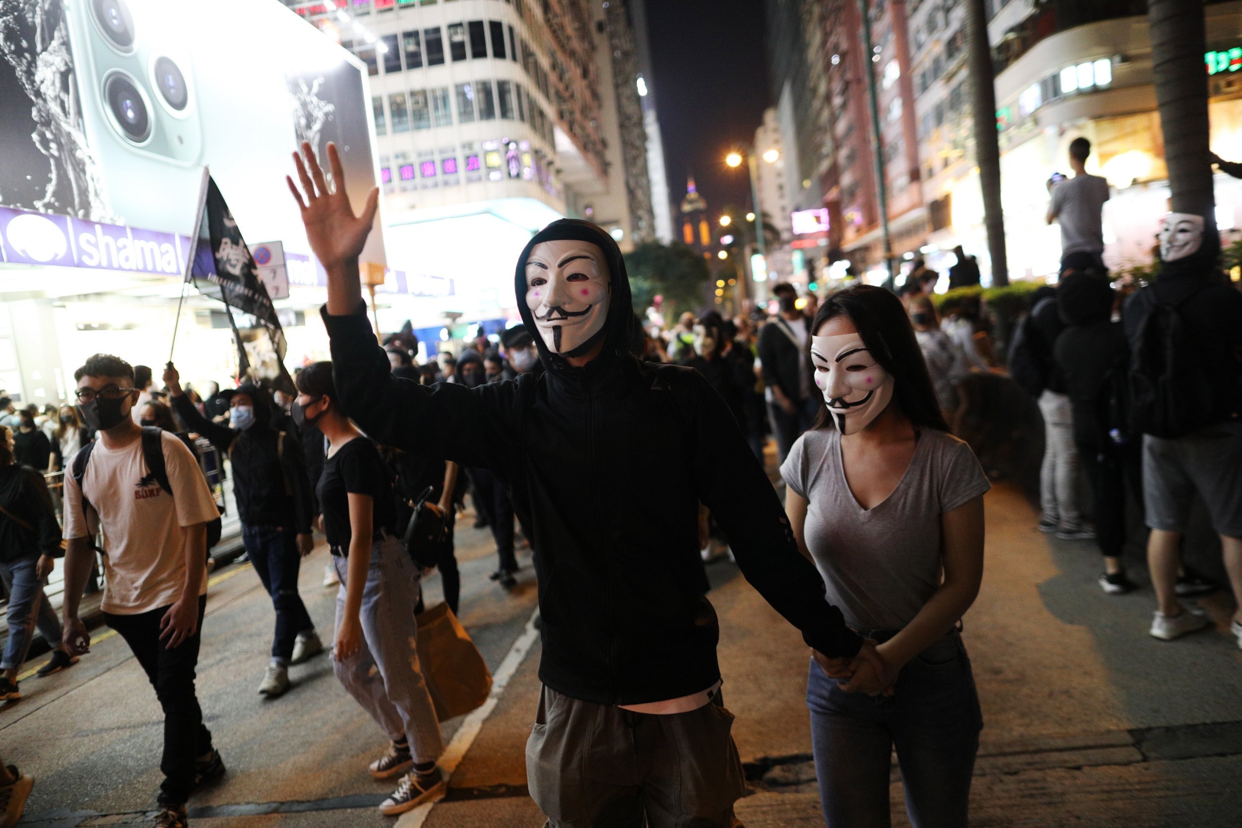 Protesters wear 'Guy Fawkes' masks as they take part in a rally in Hong Kong on Tuesday