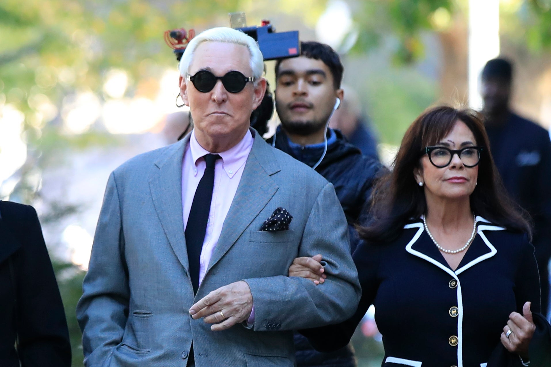 Roger Stone, flanked by his wife Nydia Stone, arrives at the federal court in Washington DC for the first day of his trial
