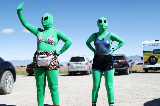 Women dressed as aliens at a Storm Area 51 spinoff event called Alienstock on 20 September in Rachel, Nevada