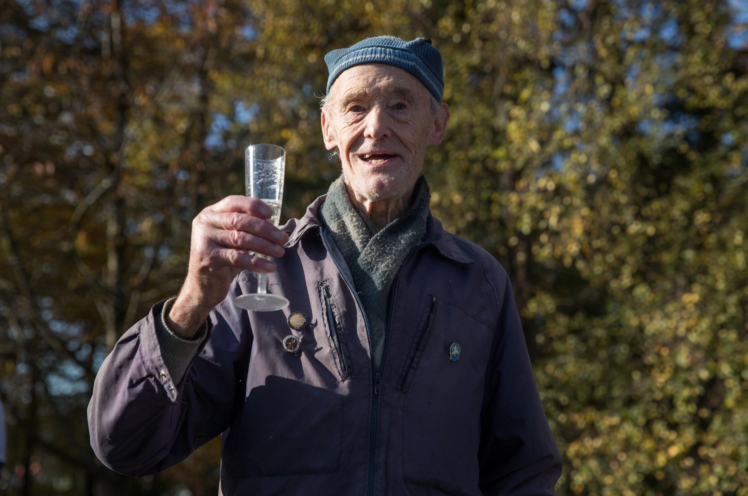 The former carpenter celebrated his triumph with a glass of fizz (PA)