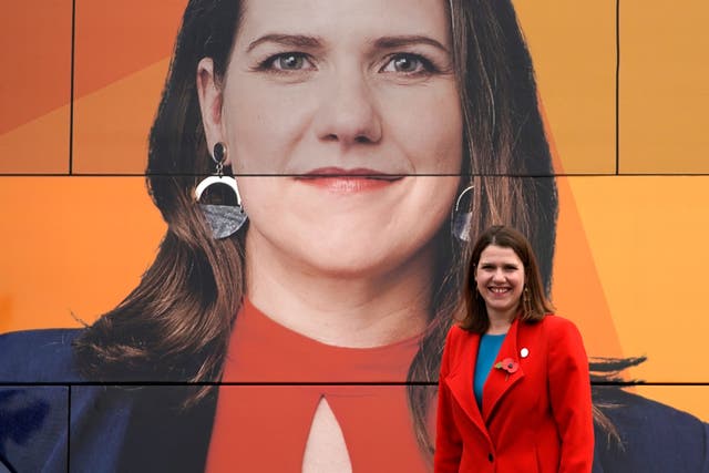 Liberal Democrat leader Jo Swinson poses for photographs by the party’s election bus