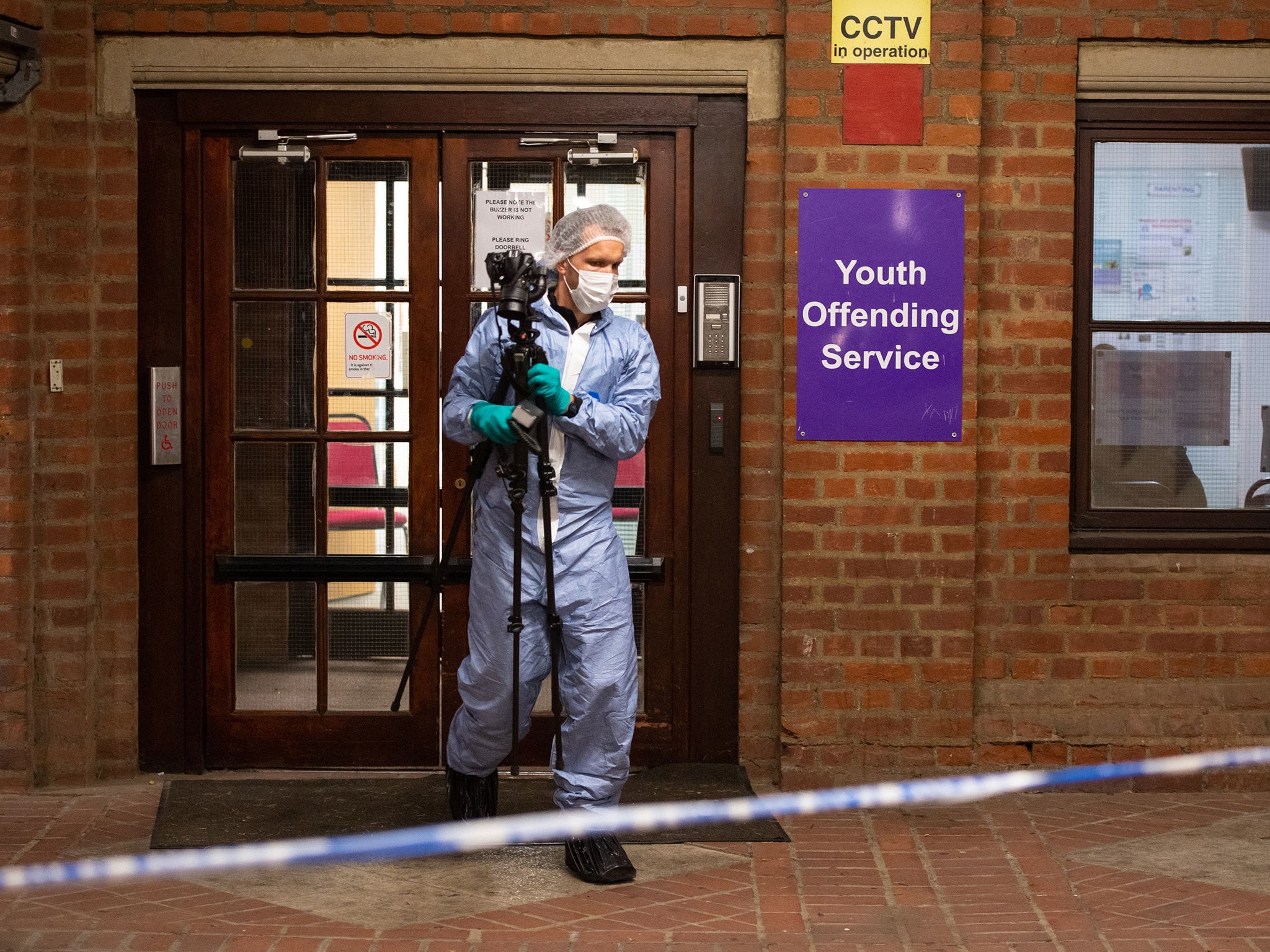 Police forensics officers at the scene civic centre building in Uxbridge, west London, following the stabbing of a teenager in the chest