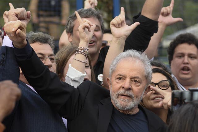 Former Brazilian president Lula gestures as he leaves prison, where he had been detained since April 2018