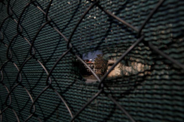 A Turkish flag can be seen through a hole in the fence which divides the capital of Cyprus in two