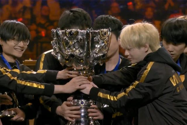 Chinese team FPX lift the Summoner's Cup after winning the 2019 League of Legends World Championship finals