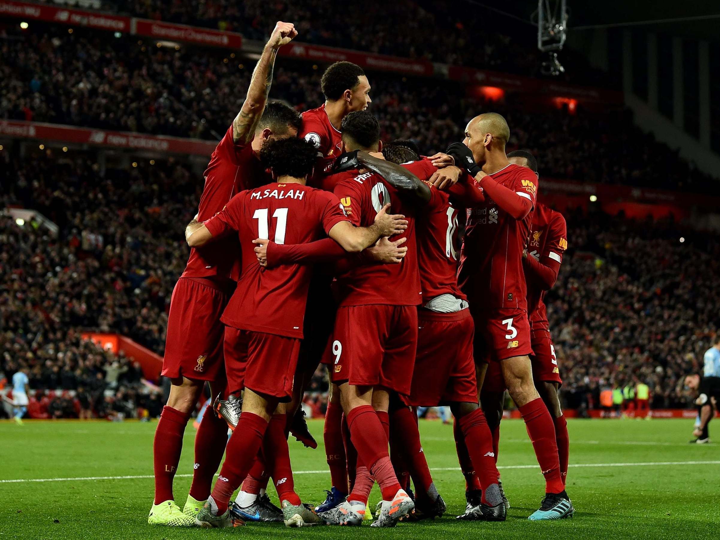 Liverpool celebrate after scoring their third against City