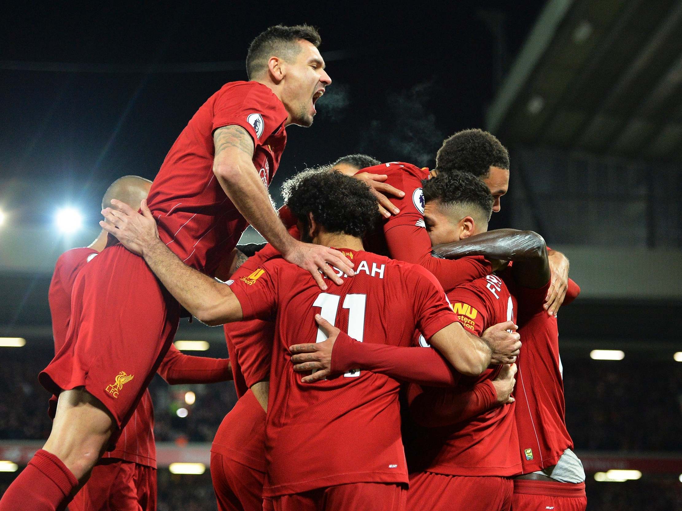 Liverpool celebrate after taking a 3-0 lead over the champions