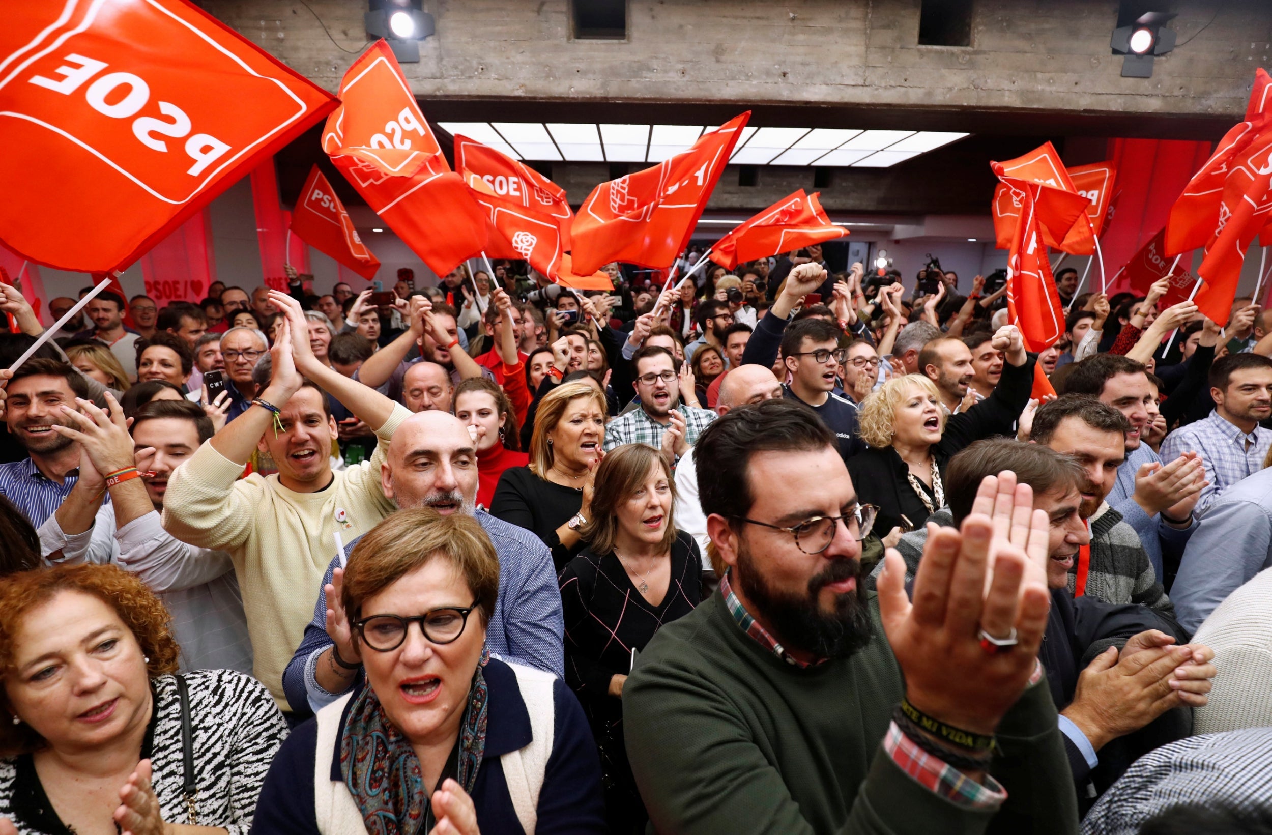 Supporters of Spain's acting prime minister and Socialist Party leader (PSOE) candidate Pedro Sanchez react to the results at party headquarters in Madrid