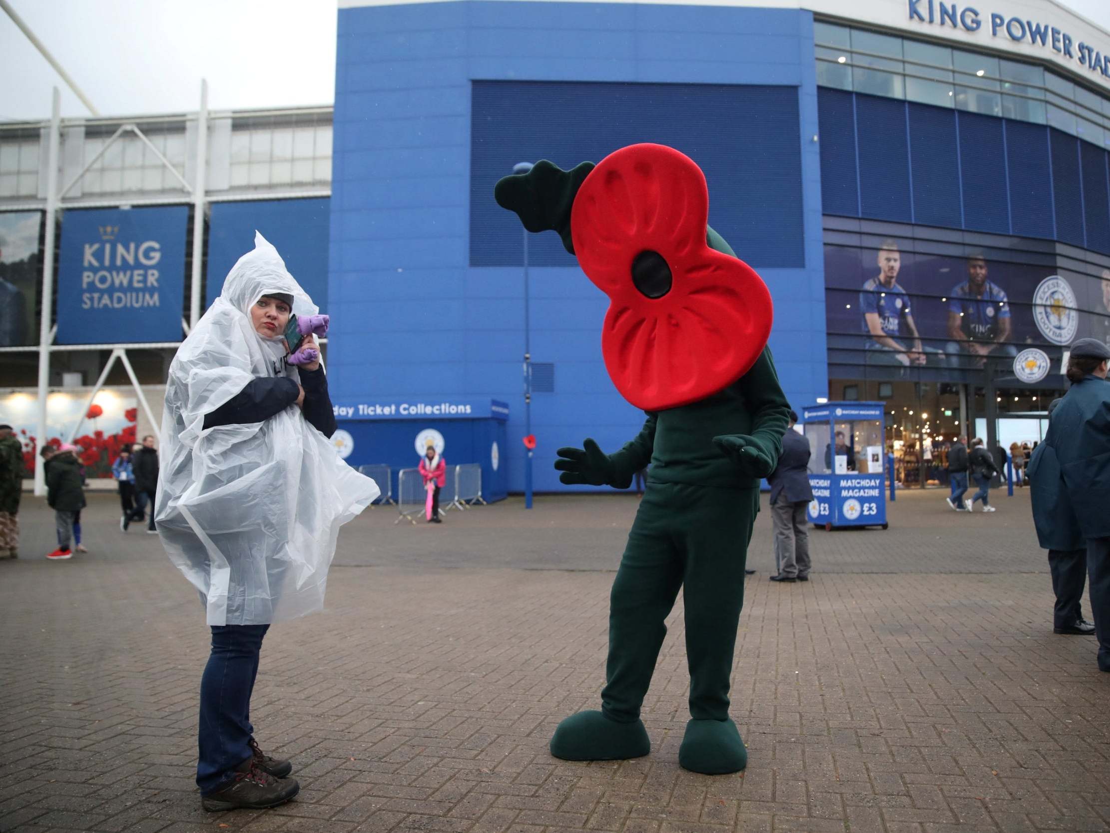 A poppy mascot outside the stadium at Leicester City
