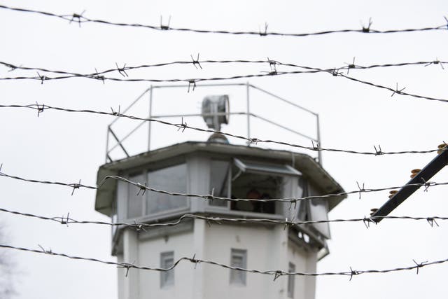 A watchtower behind a barbed fence on the former border between East and West Germany