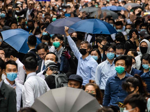 Office workers and pro-democracy protesters gather during a demonstration in Central in Hong Kong on Tuesday