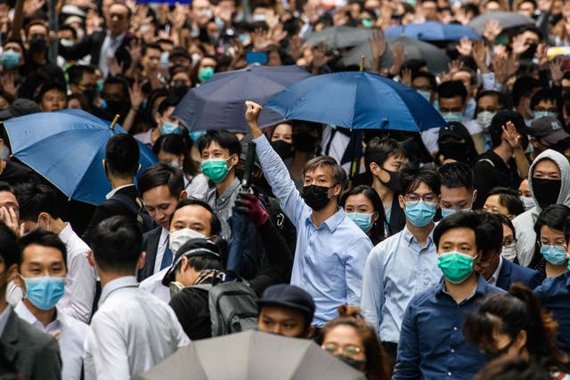 Office workers and pro-democracy protesters gather during a demonstration in Central in Hong Kong on Tuesday