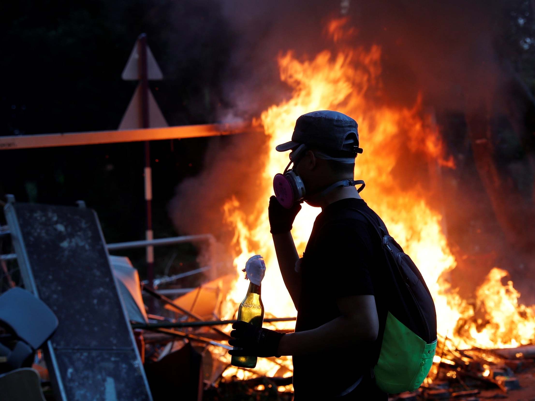 A protester holds a Molotov cocktail as university students standoff with riot police at the Chinese University of Hong Kong