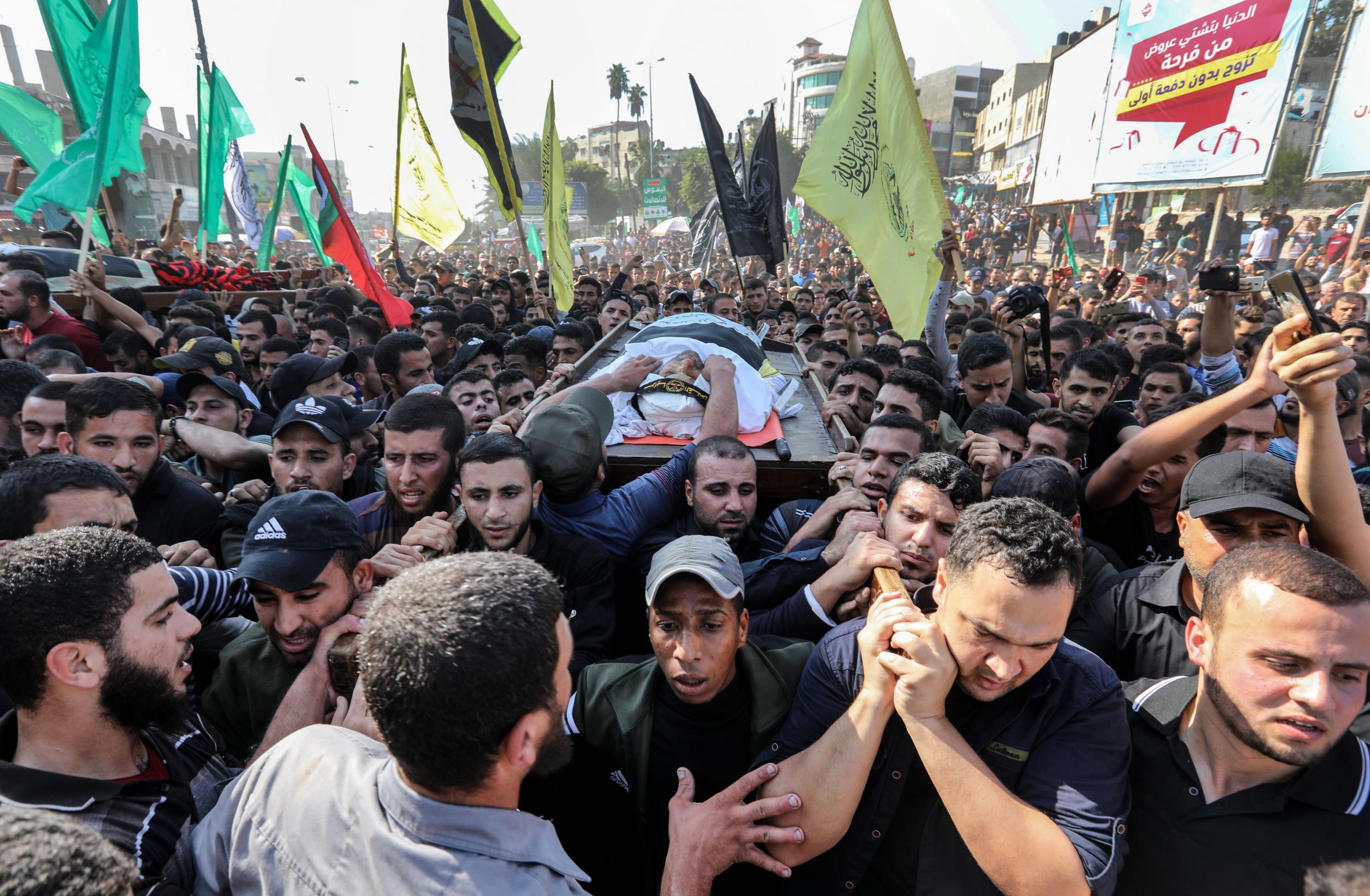 Mourners carry the body of Baha Abu Al-Ata during his funeral in Gaza City (Mahmud Hams/AFP via Getty)