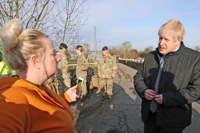 Boris Johnson talks to a woman during a visit to Stainforth, Doncaster