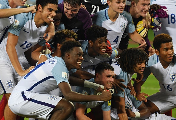 England's players celebrate in Kolkata, India